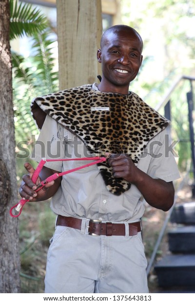 HAZYVIEW, SOUTH AFRICA -\
OCTOBER 1, 2018: Lodge employee protects tourists from monkeys with\
slingshot in Singita lodge located in Sabi Sands Game Reserve,\
South Africa