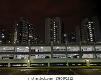 HDB Flat And Car Park In Singapore At Night With Lights 