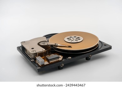 HDD, Hard disk drive, platters, circular magnetic disk. Actuator arm with read write head. Central spindle. Circuit board. Mechanical and electronic components. Precision device for data storage. - Powered by Shutterstock