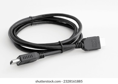 HDMI Cable for connecting a computer to a monitor and other multimedia consumer electronics, close-up in selective focus on a white background