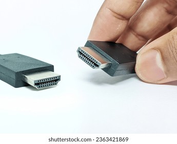 HDMI male port in hands - Shutterstock ID 2363421869