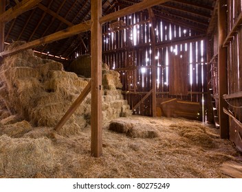 HDR image of an old Barn with the sun streaming from outside and straw and hay on the floor of the hayloft - Shutterstock ID 80275249