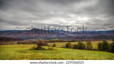 An HDR image of a valley and fall colors and overcast cloudy sky in the mountains of Tennessee.