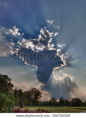 Similar – Foto Bild Wolken mit Sonnenstrahlen vor bergigen Vordergrund