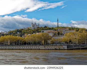 HDR view of Fourviere hill with Saone river and Bondy quay in front, cloudy  mid-day sky, Lyon, France - Shutterstock ID 2394926225