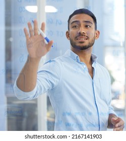 He Always Has A Plan To Follow. Shot Of A Young Businessman Writing Notes On A Glass Wall In An Office.