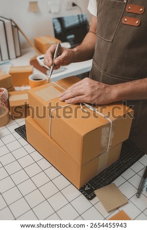 he is checking the boxes in the packing room, a small business owner is preparing boxes to ship to customers, product, e-business, entrepreneurs in online sales and export businesses