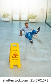 He Didnt Read The Sign. Shot Of A Man Cleaning An Office Building.