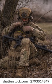 He doesn't look up, because the mission hasn't started yet. Right now, only the weapon matters — its readiness, its reliability, its silence.