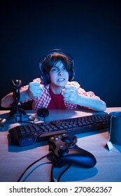 He Is Going To Revenge To Another Player. He Like Play And Win Video Games. In Blue Light Of Display Emotional Kid Play Computer Games Online.