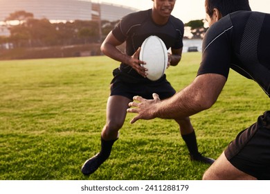 Is he going to tackle me. Cropped shot of two handsome sportsmen playing rugby during a training session during the day. - Powered by Shutterstock