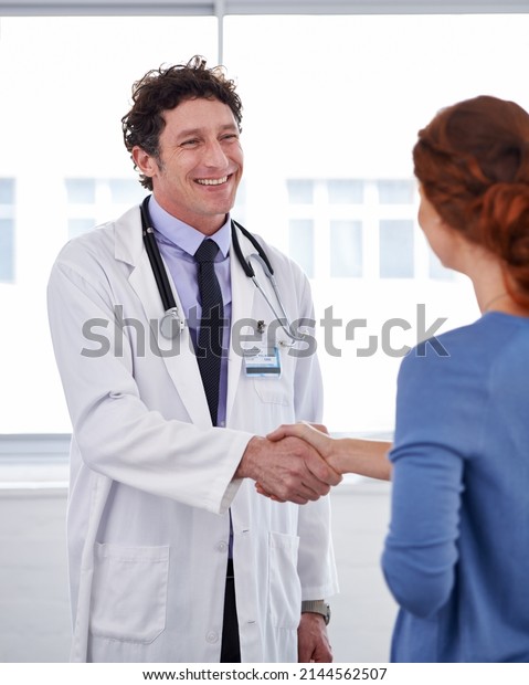 He has a good bedside manner. Cropped shot\
of a doctor and shaking his patients\
hand.