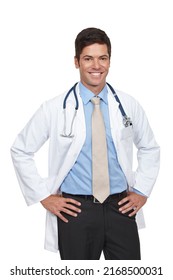 He Has A Great Bedside Manner. Studio Shot Of A Young Doctor Standing With His Hands On His Hips.