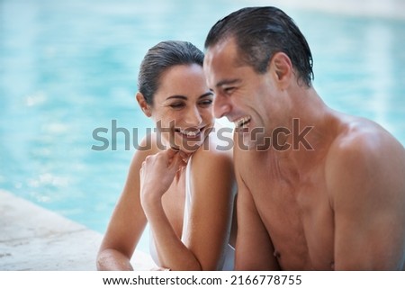 He knew how to make her laugh. Cropped shot of a loving mature couple relaxing in a pool.