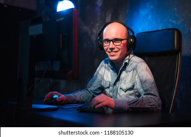He like play and win video games. In blue light of display emotional man play computer games online. - Shutterstock ID 1188105130