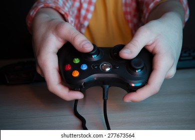 He like play and win video games. In blue light of display emotional kid play computer games online. - Shutterstock ID 277673564