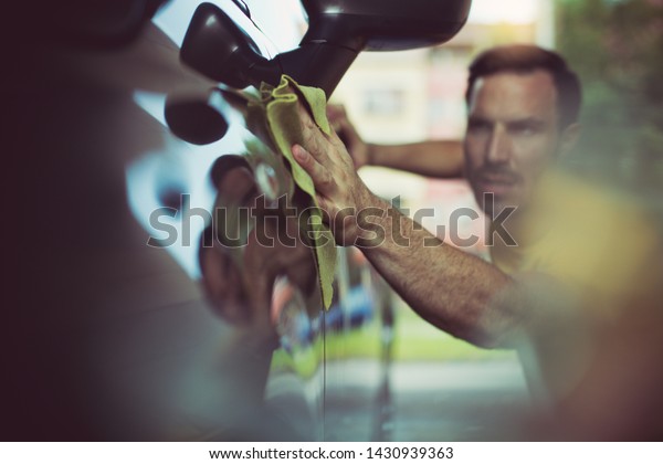 He love\
to cleaning his car. Man cleaning his\
car.