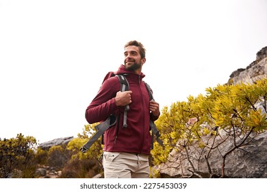 He loves to hike. a young man enjoying a hike through the mountains.