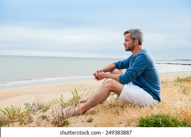 He is meditating, looking at the ocean - Powered by Shutterstock