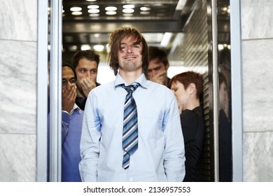 He needs a shower. A dirty young businessman affecting his coworkers in an elevator.