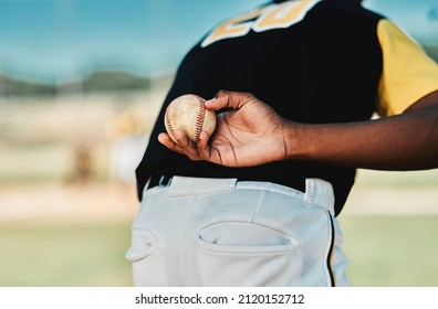 He Plays His Position Well. Rearview Shot Of A Baseball Player Holding The Ball Behind His Back.