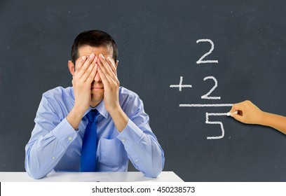 He stressed teacher in a class with a child on the board making a mathematical calculation wrong - Powered by Shutterstock