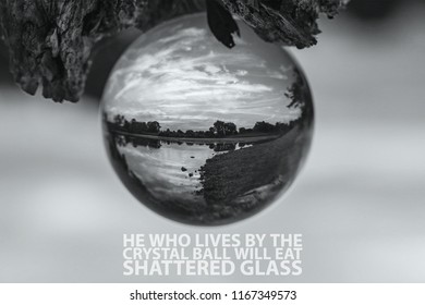 He Who Lives By The Crystal Ball Will Eat Shattered Glass Saying. Inspirational Quote With A Sunrise/sunset Through A Glass Ball.