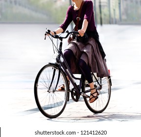 He Woman On The Bike After Work. Urban Scene.