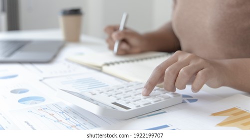 Head Of Accounting Is Recording The Company's Financial Growth Statistics Using Graphs As A Reference For Reviewing And Analyzing The Results, Taking Notes And Analyzing Data Graphs In Office.