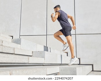 Head up and aim high. Low angle shot of a sporty young man running up a staircase while exercising outdoors. - Shutterstock ID 2294074207