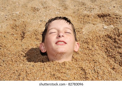head of a boy buried in the sand