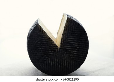 The Head Of Cheese In Black Wax With A Piece Cut From It Lies On Its Side