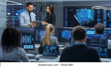 Head of the Department and Project Manager Discuss Work Process Using Data on Tablet Computer. Multi-Ethnic Team Builds Neural Network with Integrated Machine Learning. - Powered by Shutterstock - Get 15% off with code: PIKWIZARD15