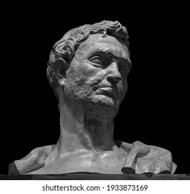 Head Detail Of The Ancient Man Sculpture. Stone Face Isolated On Black Background. Antique Marble Statue Of Mythical Hero Character