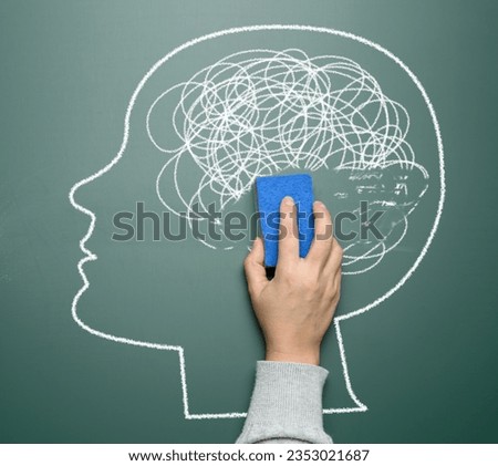 The head is drawn in white chalk and is in profile. The head has a tangled mess of lines inside it, representing a confused or cluttered mind 