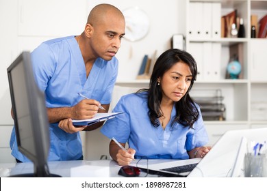 Head Gives Task To Assistant At Office At Table