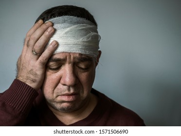 Head Injury. Mature Man With Bandaged Forehead