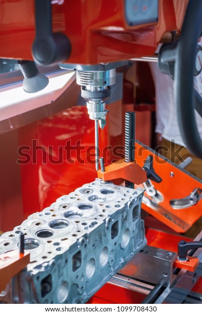The head of the internal combustion engine is
mounted on the grinding
machine.