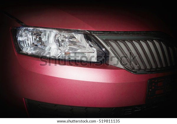 Head lamp and grill of red\
car