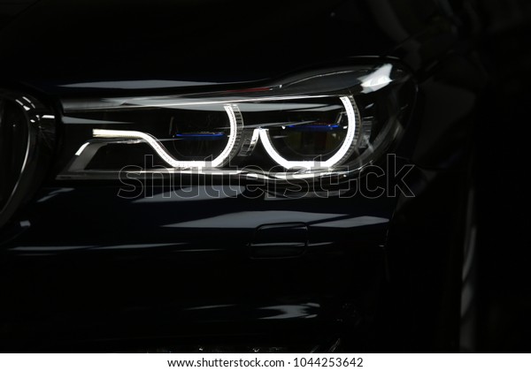head lamps of the car in dark . its look like the\
eye of the beast.
