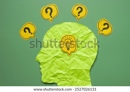 Head with light bulb and question marks around. Ideas and creativity.
