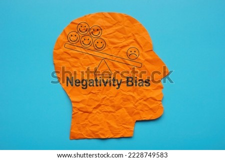 Head from paper and inscription Negativity bias.