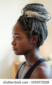 Head Of Pensive Young Black Woman With Braided Hair In Bun Looking In Front Of Her