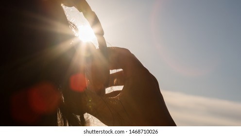 Head Portrait Of Girl In Headphones Listening To Music At Sunset, Back View, Close-up