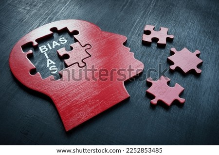 A Head with puzzle pieces and word bias.