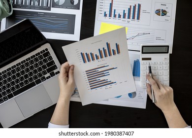 The head sales department checks the monthly sales datasheet for the salesperson to calculate the monthly commission, she looks at the document and presses the calculator. Sales management concept - Shutterstock ID 1980387407
