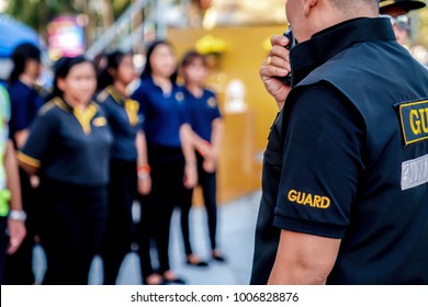 Head Of Security Guard Call Meeting And Talk Into Walkie Talkie For Communication To The Team.