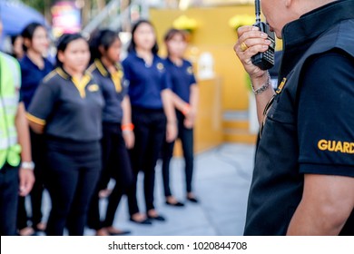 Head Of Security Guard Call Meeting And Talk Into Walkie Talkie For Communication To The Team.