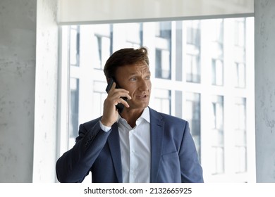 Head Shod Focused Serious Middle Aged Male Ceo Executive Manager Leader Boss Financial Advisor Holding Phone Call Conversation With Colleagues Or Giving Professional Consultation To Client In Office.