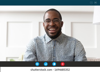 Head Shot African Guy Sit On Sofa Look At Webcam Laptop Screen View. Online Edating Service User, Teacher Provide Class Distantly By Videocall, Informal Communication Via Videoconferencing App Concept